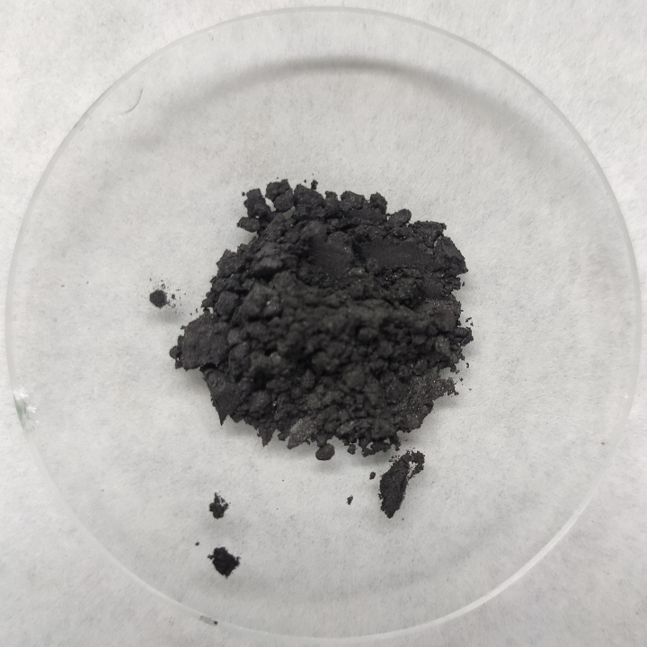 Activated carbon powder and granules on a glass dish, shown as a reference material